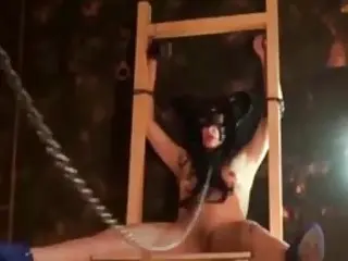 Bound BDSM slave girl enjoys being punished by her master